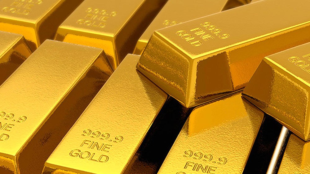 Lingotti d'oro lucidi impilati con la scritta incisa 999.9 Fine Gold sulla superficie